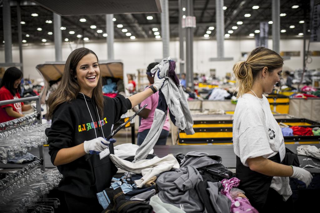 Students sorting clothes in warehouse